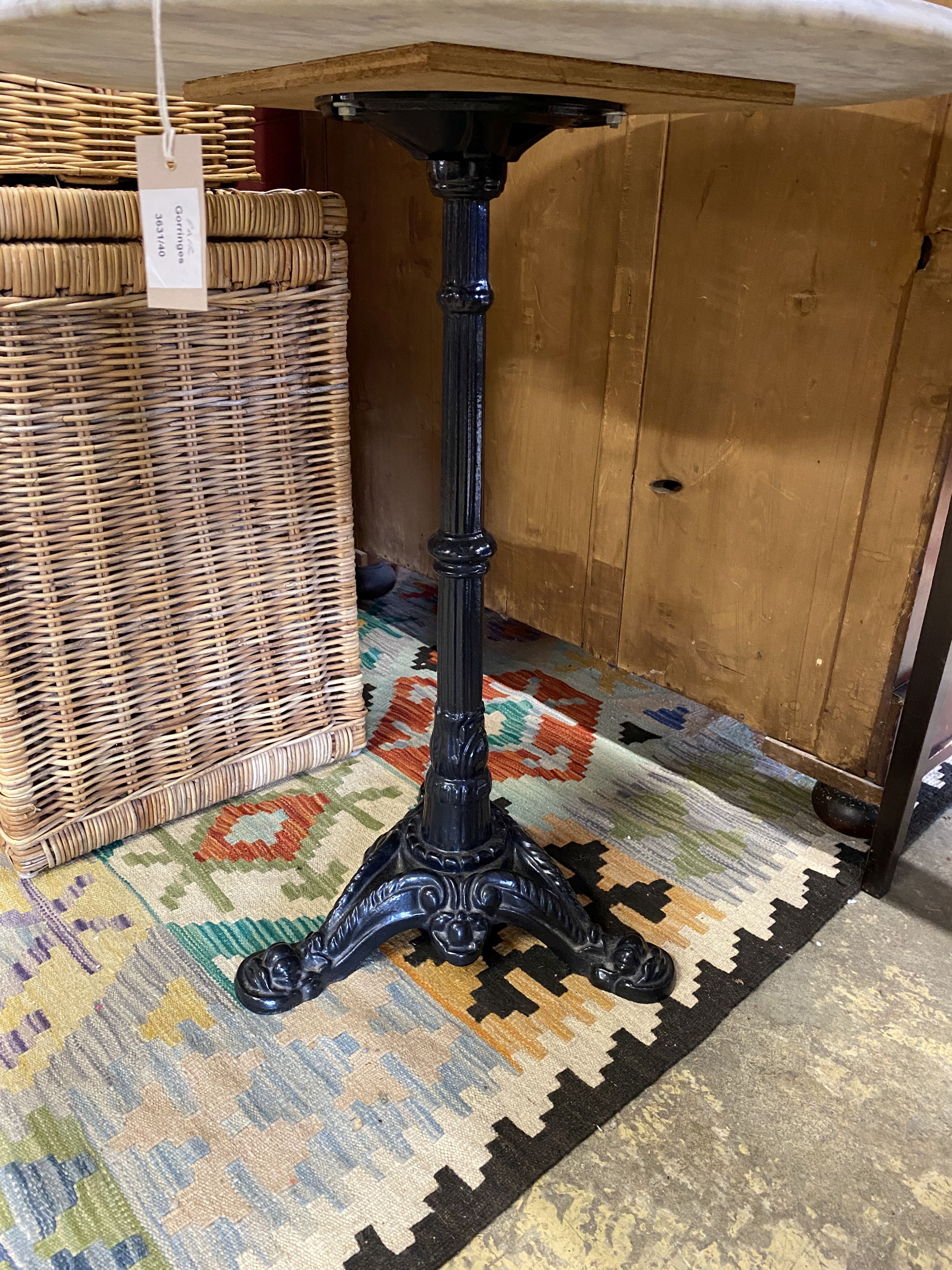 A pair of Victorian style cast iron circular marble topped pub tables, diameter 64cm, height 72cm